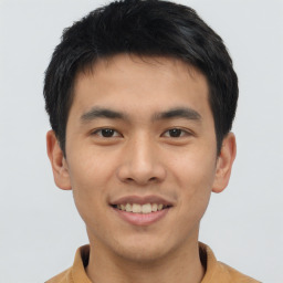 Joyful asian young-adult male with short  brown hair and brown eyes