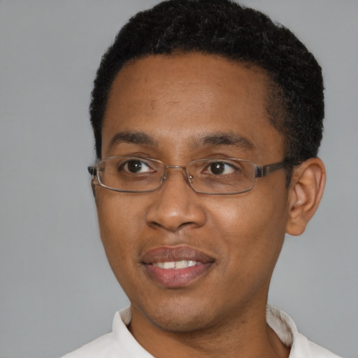 Joyful black young-adult male with short  black hair and brown eyes