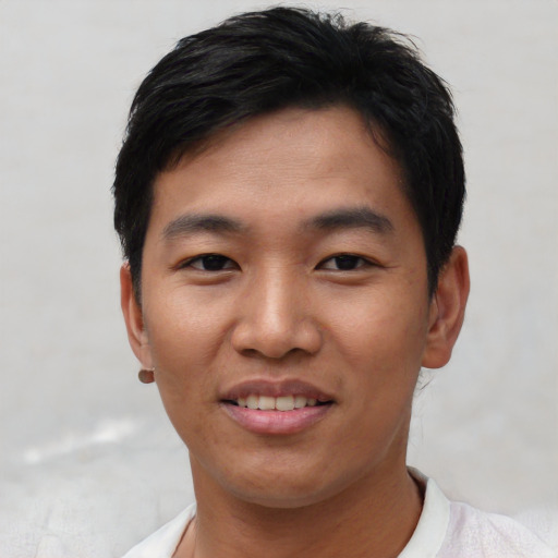 Joyful asian young-adult male with short  black hair and brown eyes