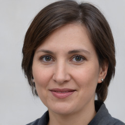 Joyful white adult female with medium  brown hair and brown eyes