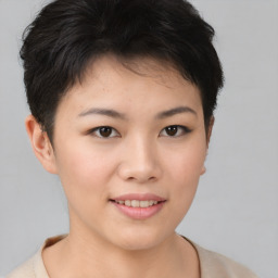 Joyful asian young-adult female with short  brown hair and brown eyes