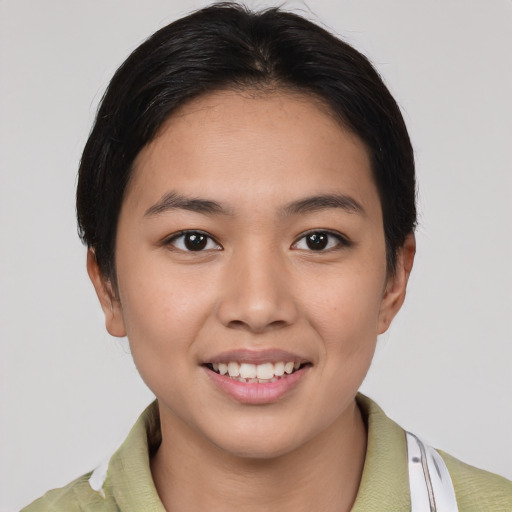 Joyful asian young-adult female with short  brown hair and brown eyes