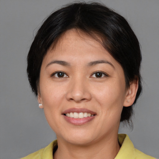 Joyful asian adult female with short  brown hair and brown eyes