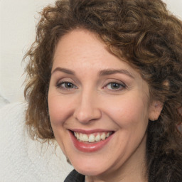 Joyful white adult female with medium  brown hair and brown eyes