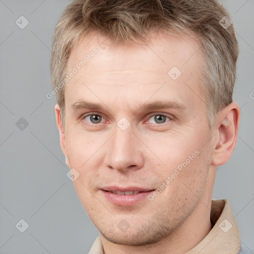 Joyful white adult male with short  brown hair and grey eyes