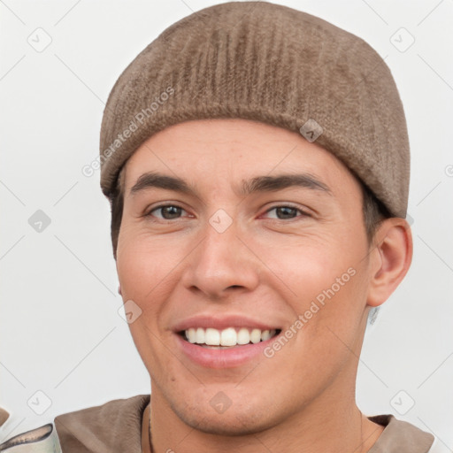 Joyful white young-adult male with short  brown hair and grey eyes