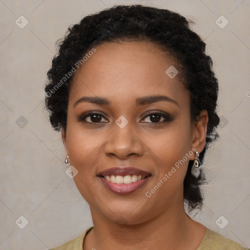 Joyful black young-adult female with long  brown hair and brown eyes