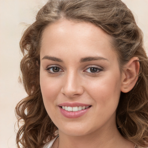 Joyful white young-adult female with long  brown hair and green eyes