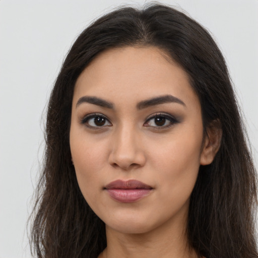 Neutral latino young-adult female with long  brown hair and brown eyes