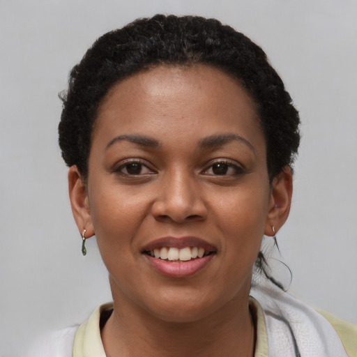 Joyful latino young-adult female with short  brown hair and brown eyes