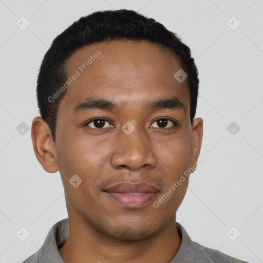 Joyful black young-adult male with short  black hair and brown eyes