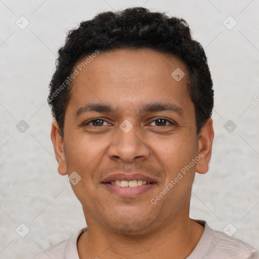 Joyful latino young-adult male with short  brown hair and brown eyes