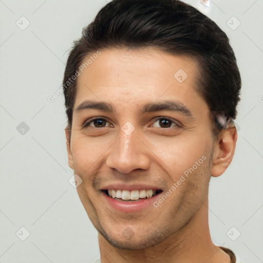 Joyful white young-adult male with short  brown hair and brown eyes