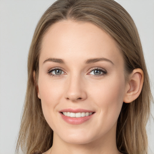 Joyful white young-adult female with long  brown hair and grey eyes