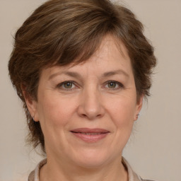 Joyful white adult female with medium  brown hair and grey eyes