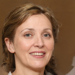 Joyful white adult female with medium  brown hair and grey eyes