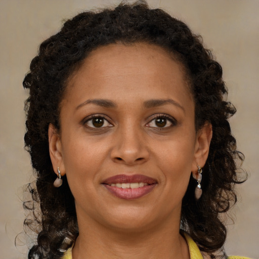 Joyful black young-adult female with medium  brown hair and brown eyes