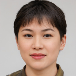 Joyful asian young-adult female with short  brown hair and brown eyes