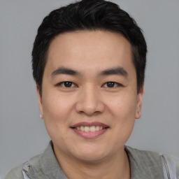 Joyful asian young-adult male with short  black hair and brown eyes