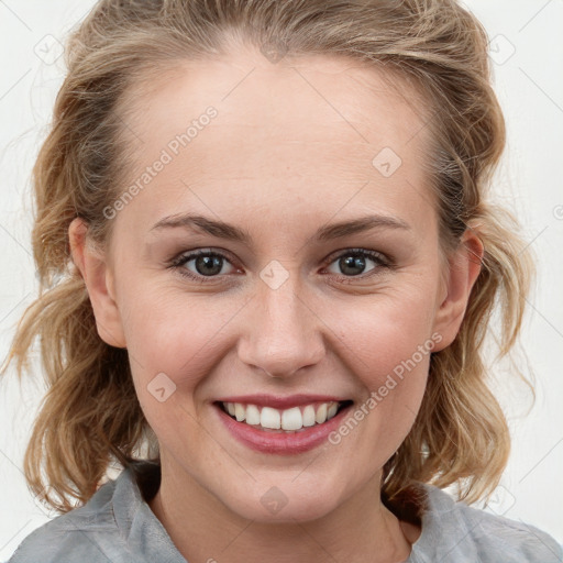 Joyful white young-adult female with medium  brown hair and blue eyes