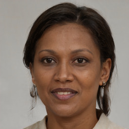 Joyful black adult female with medium  brown hair and brown eyes