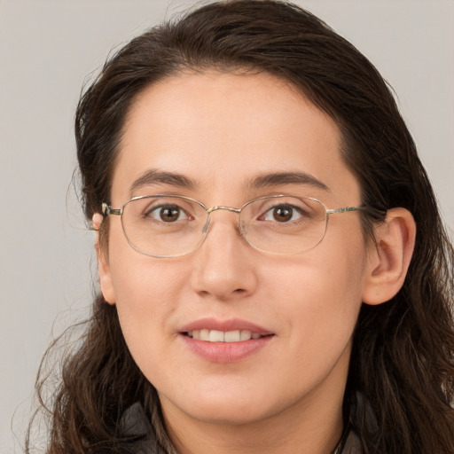 Joyful white adult female with long  brown hair and brown eyes