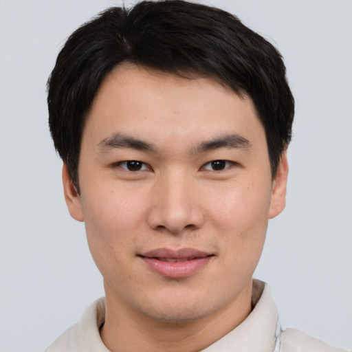Joyful asian young-adult male with short  brown hair and brown eyes