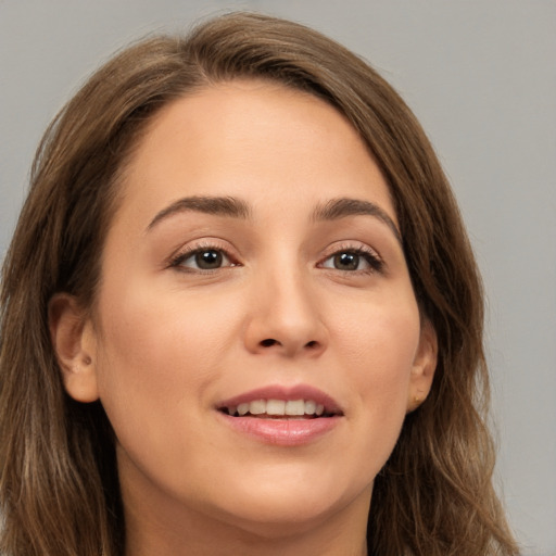 Joyful white young-adult female with long  brown hair and brown eyes