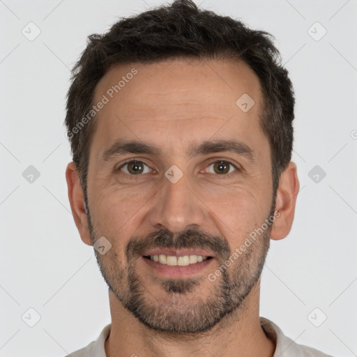 Joyful white young-adult male with short  black hair and brown eyes