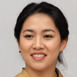 Joyful asian young-adult female with medium  black hair and brown eyes