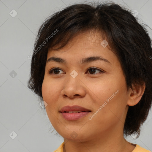 Joyful asian young-adult female with medium  brown hair and brown eyes