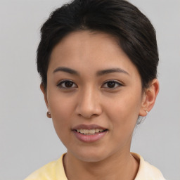 Joyful asian young-adult female with short  brown hair and brown eyes