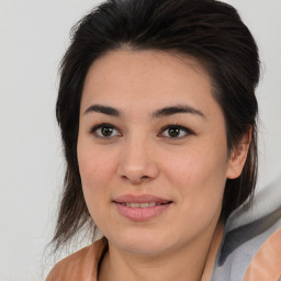 Joyful asian young-adult female with medium  brown hair and brown eyes