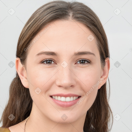 Joyful white young-adult female with long  brown hair and grey eyes