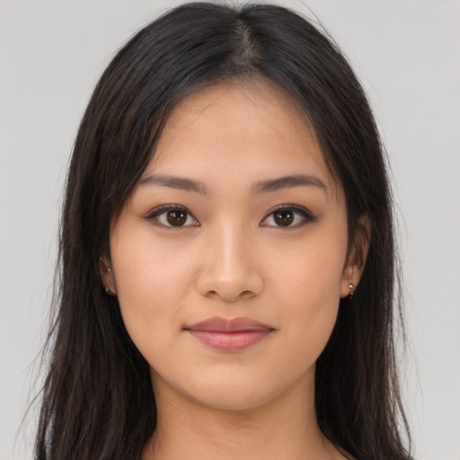 Joyful asian young-adult female with long  brown hair and brown eyes