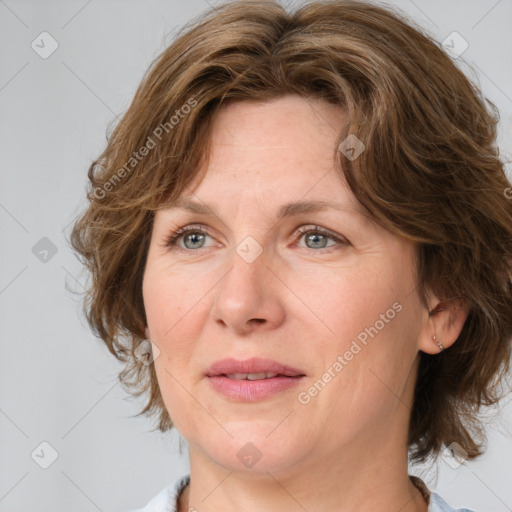 Joyful white adult female with medium  brown hair and blue eyes