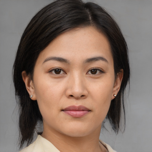 Joyful asian young-adult female with medium  brown hair and brown eyes