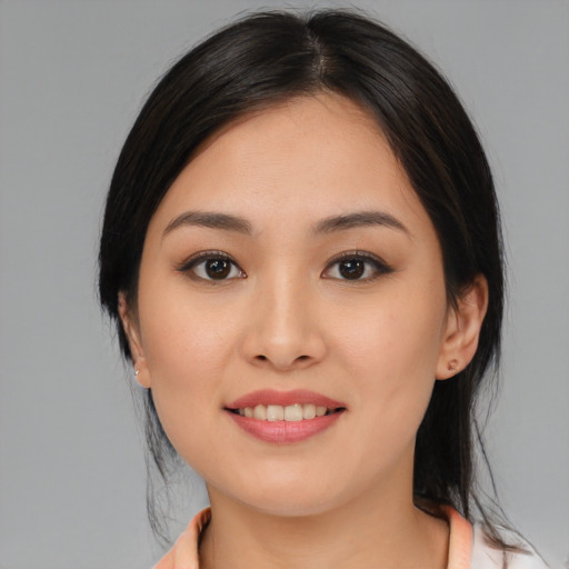 Joyful asian young-adult female with medium  black hair and brown eyes