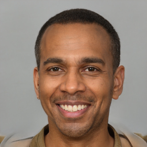 Joyful latino adult male with short  brown hair and brown eyes