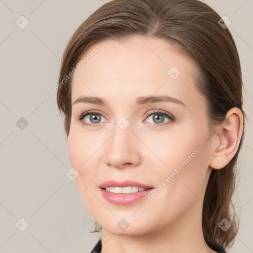 Joyful white young-adult female with medium  brown hair and grey eyes