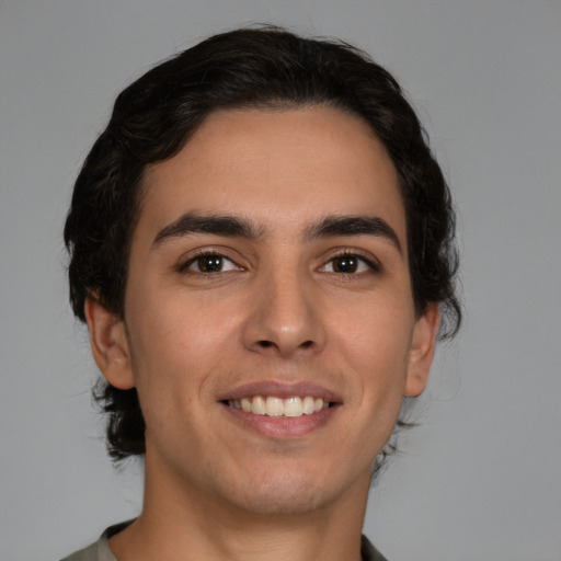 Joyful white young-adult male with medium  brown hair and brown eyes