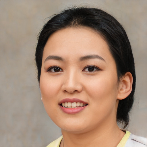 Joyful asian young-adult female with medium  black hair and brown eyes
