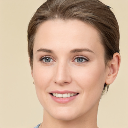 Joyful white young-adult female with short  brown hair and grey eyes