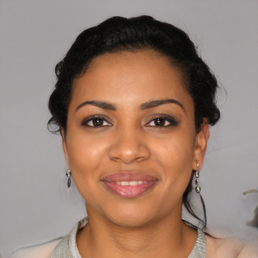 Joyful black young-adult female with short  black hair and brown eyes