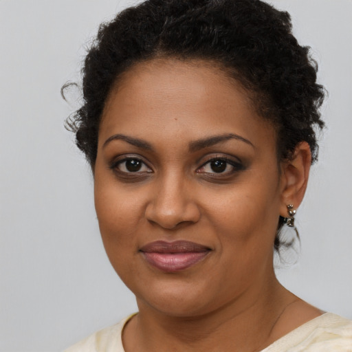 Joyful black young-adult female with short  brown hair and brown eyes