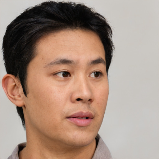 Neutral asian adult male with short  black hair and brown eyes