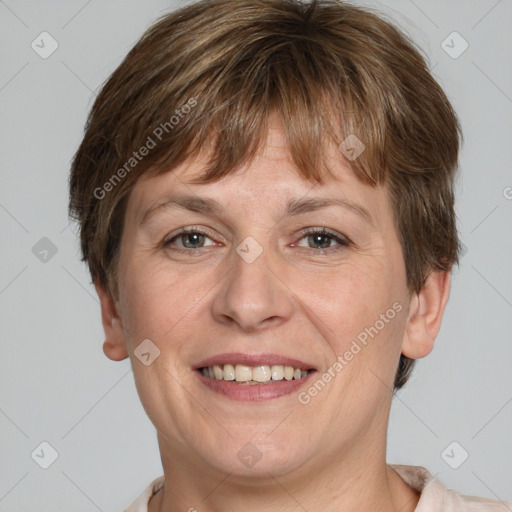 Joyful white adult female with short  brown hair and grey eyes