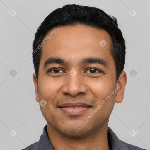 Joyful latino young-adult male with short  black hair and brown eyes