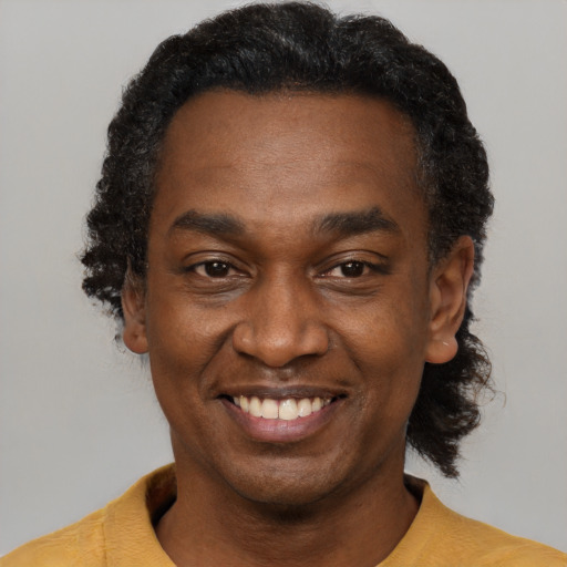 Joyful latino adult male with short  black hair and brown eyes