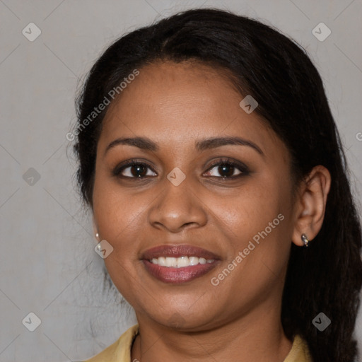 Joyful black young-adult female with long  brown hair and brown eyes